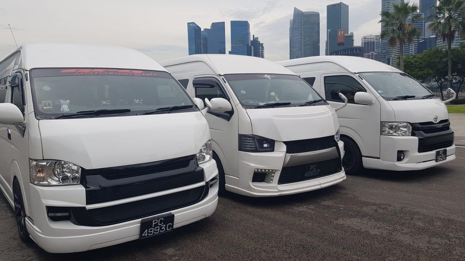 SKO Limousine maxi cabs with the Singapore central business district skyline behind