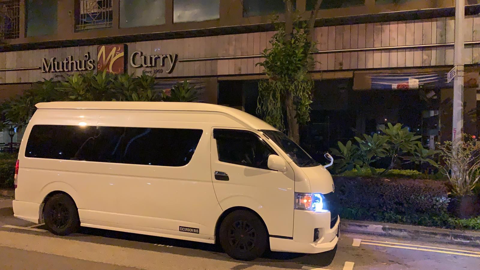 SKO 9-seater maxi cab parked outside a restaurant at night